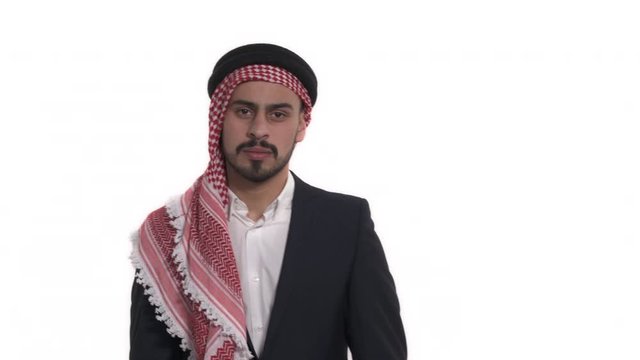 Millennial man in traditional Saudi clothes whispering. Body language and gestures. Isolated, on white bacground