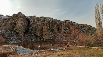 Ancient stone cave houses carved into the volcanic rock in Cappadocia, Turkey