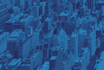 Overhead view of the crowded buildings of Midtown Manhattan in New York City with blue monotone effect