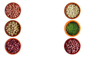Phaseolus. Bright multi-colored beans, mung beans and chickpeas in ceramic cups. A complete source of vegetable protein in vegetarianism. Isolated on white.