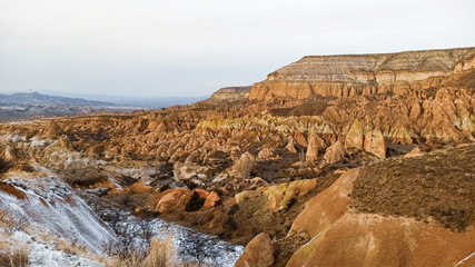Fototapeta na wymiar Red Valley in Cappadocia, Turkey. Unique volcanic landscape and geologic rock formations in Cappadocia.