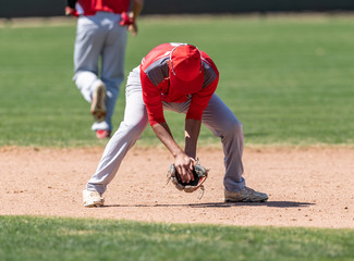 Young boys playing in high school baseball game