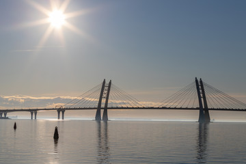View from Vasilievsky island of St. Petersburg on the high- speed bridge over the Neva river. Sunset on the river and Bay.