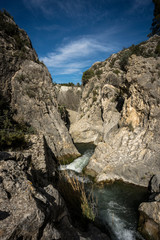 Small Mediterranean river, channeled between rocks