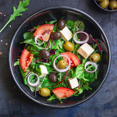 healthy salad olives, lettuce, tomato and cheese feta (greek salad, tasty vegetables snack) menu concept background. top view. copy space for text
