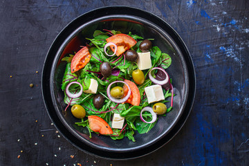 healthy salad olives, lettuce, tomato and cheese feta (greek salad, tasty vegetables snack) menu concept background. top view. copy space for text