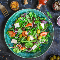 healthy salad olives, lettuce, tomato and cheese feta (greek salad, tasty vegetables snack) menu concept background. top view. copy space for text