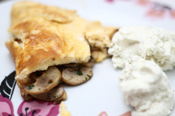 Omelette with fried champignon mushrooms  and cottage cheese