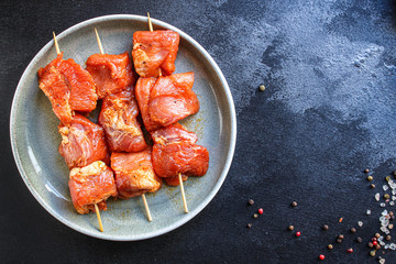 raw meat pork or beef in a plate on the table (preparing healthy food, marinade and spices paprika) menu concept background. top view. copy space for text