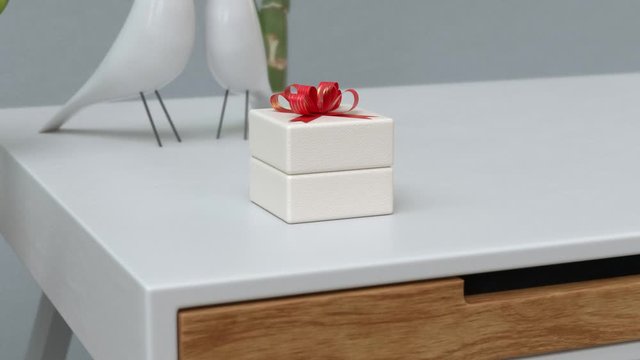 white gift box with red ribbon on white table. Jewel box with red bow. 3d render