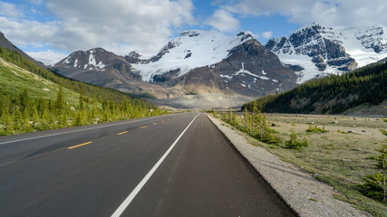 Highway with mountain range in the background, Icefield Parkway, Alberta, Canada