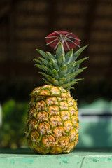pineapple cocktail on a wooden table close-up