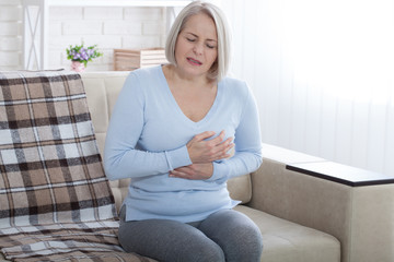 Portrait of middle aged woman having heart attack