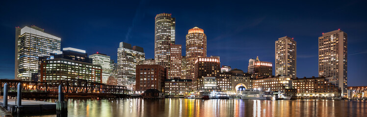 Downtown panoramic city view of Boston Massachusetts looking over the riverfront harbor at night