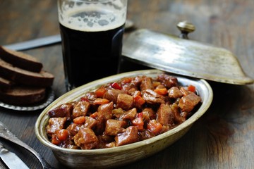 Traditional Irish Stew. an Irish dish for St. Patrick's Day. stewed in dark guinness beer - obrazy, fototapety, plakaty