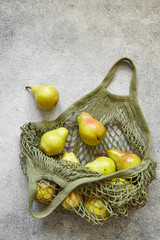 Juicy pears in a green bag
