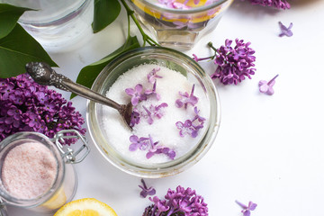 homemade lemonade with lilac flowers in glass. lilac sugar