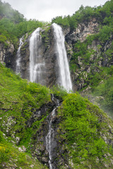 Fototapeta na wymiar View of the waterfall in Caucasian mountains