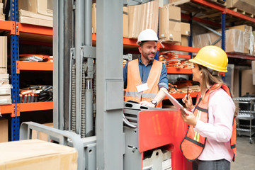 Female And Male Coworkers Talking At Warehouse © AntonioDiaz