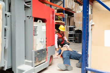 Fototapeta na wymiar Employee Looking At Worker In Warehouse