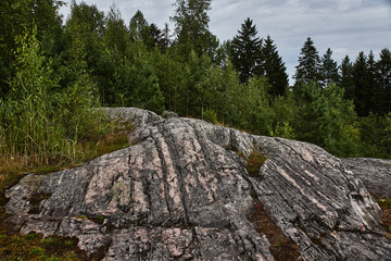 Panorama of the city from a height.Panoramic view of the city of Sortavala from a hill in a city park: a forest of conifers, traces of volcanic lava, rocks and volcanic rocks. Russia, Karelia