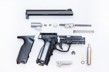 Fototapeta premium Dismantling a gas gun top view, on a white background