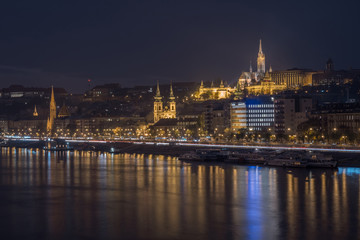Fototapeta na wymiar Danube river and illuminated historic boildings at night in Budapest, Hungary