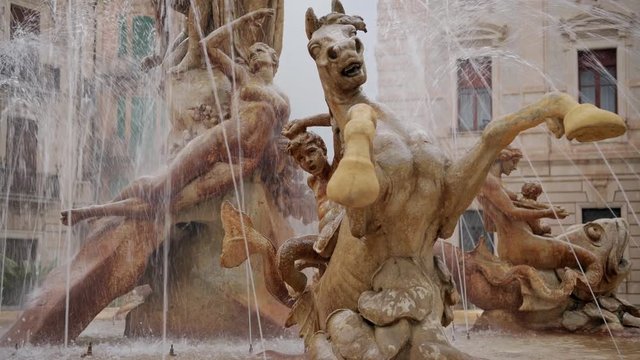 Close view of the sculpture of horse, as a part of famous fointain Diana in the center of Archimedes square in Ortygia island in Sicily