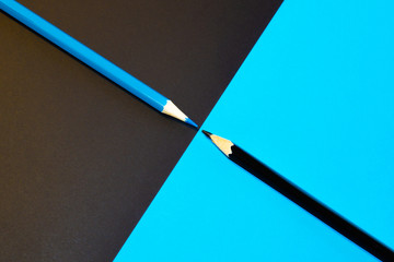 Black and blue pencil facing each other. Minimal Aesthetic.