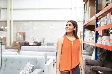 Young Latin Woman Looking Away In Furniture Store