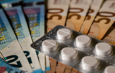 Medical pills, tablets on European bank notes, Euro currency