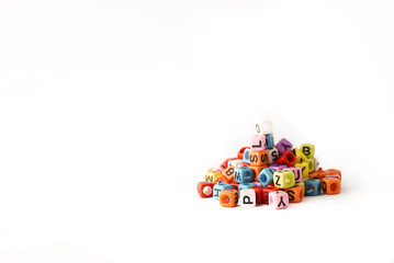 Small coloring alphabet cubes on the white background