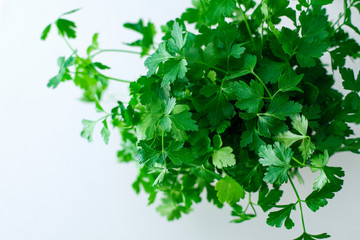 Green, fresh parsley seen from above against a white background