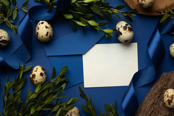 card mockup with envelope. quail eggs, leaves on classic blue Easter background. invitation postcard