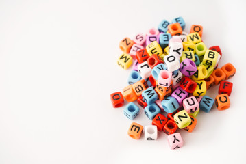 Small coloring alphabet cubes on the white background