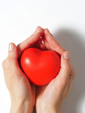 red heart in open women's hands, isolated on a white background. Concept of the day of health, charity, love