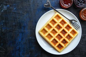 Belgian or Viennese waffles (delicious sweet dish, dessert snack) menu concept. background. top view. copy space for text