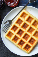 Belgian or Viennese waffles (delicious sweet dish, dessert snack) menu concept. background. top view. copy space for text
