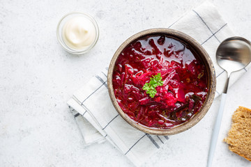 Traditional Ukrainian Russian vegetable beet soup, borscht on white background, top view