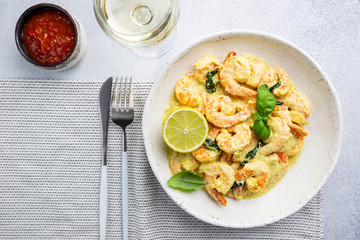 Shrimps in cream sauce with Coconut milk on a plate, top view or view from above, flat lay