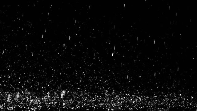 Close up shot of heavy droplets of rain falling on the surface of an isolated background