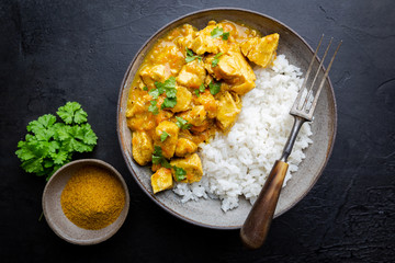Spicy chicken cooked with curry sauce and rice, top view