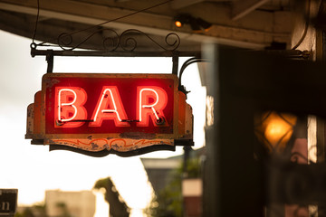 Neon bar sign hangs along Bourbon Street in the French quarter of New Orleans Louisiana USA in the...