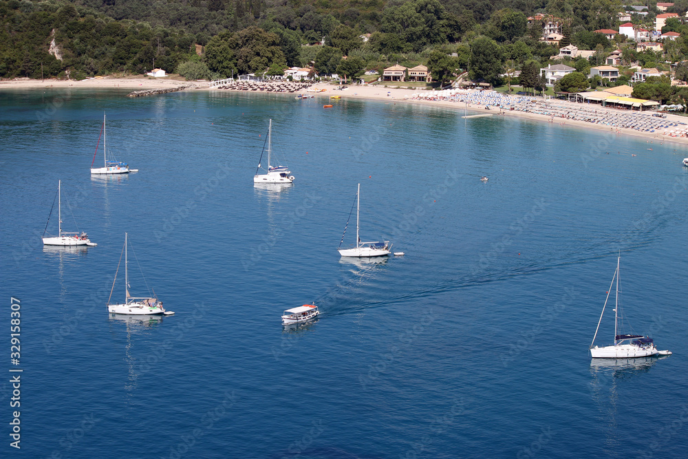 Poster yachts and sailboats on Valtos beach in summer Parga Greece