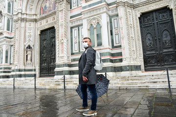 Coronavirus Covid-2019 in Italy. man in  protective medical mask in the historic center of Florence. empty Italian streets without tourists. Coronavirus in Venice Milan Lombardy Rome