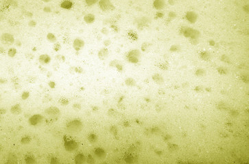 Cleaning sponge  surface close up in yellow color.