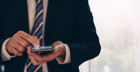 Contact us, Hand of Businessman holding mobile smartphone with ( mail, phone, email ) icon. customer support concept, copy space. man uses smart phone     