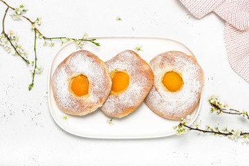 Easter food concept. Top view of homemade sweet roll bread with apricot and powdered sugar for breakfast.