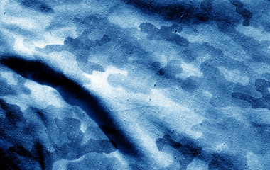 Part of military camouflage uniform close-up with blur effect in navy blue tone. © pavelalexeev