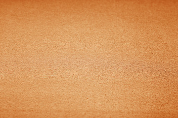 Plastic glittering texture with blur effect in orange tone.